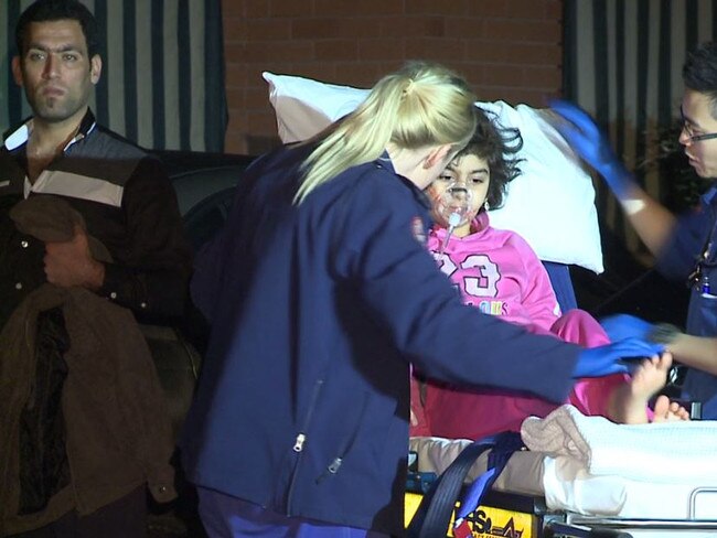 A young girl is treated by paramedics on August 31, 2014, after her and her family suffered carbon monoxide poisoning in their Liverpool home.