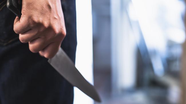 image of a robbers hands holding a knife in the shadows. Picture: iStock