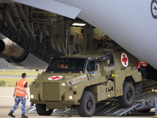 Royal Australian Air Force air movements operators from No. 23 Squadron, load a Bushmaster Protected Mobility Vehicle bound for Ukraine onto a C-17A Globemaster III aircraft, at RAAF Base Amberley, Queensland. *** Local Caption *** The Australian Government has provided further support to the Government of Ukraine by gifting 20 Bushmaster Protected Mobility Vehicles, including two ambulance variants, to aid the Government of Ukraineâs response to Russiaâs unrelenting and illegal aggression.  Australiaâs response follows a direct request from President Zelenskyy during his address to a joint sitting of the Parliament of Australian on 31 March 2022.  The Bushmaster Protected Mobility Vehicle was built in Australia to provide protected mobility transport, safely moving soldiers to a battle area prior to dismounting for close combat. The Bushmaster Protected Mobility Vehicle is well suited to provide protection to the Ukrainian Armed Forces soldiers and Ukrainian civilians against mines and improvised explosive devices, shrapnel from artillery and small arms fire.  The vehicles have been painted olive green to suit the operating environment. Additionally, a Ukrainian flag is painted on either side with the words âUnited with Ukraineâ stencilled in English and Ukrainian to acknowledge our commitment and support to the Government and people of Ukraine. The ambulances will have the traditional red cross emblem.  The Bushmaster Protected Mobility Vehicles will be fitted with radios, a global positioning system and additional bolt-on armour increasing their protection.