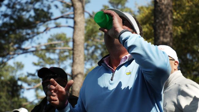 A patron finishes his beverage after a shot by Jason Day of Australia.