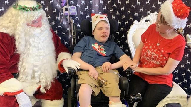 Joseph Burgess visiting Santa this year after Dr Michael Yung saved his life. Picture: Supplied by family