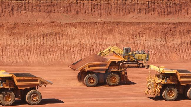 Driverless trucks loaded with ore at Rio Tinto's West Angelas Mine in Pilbara region of Western Australia.