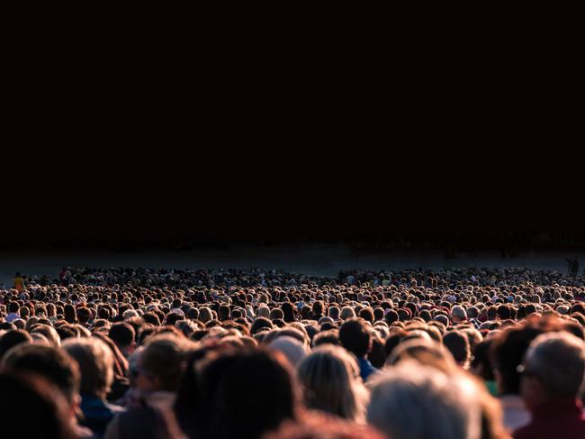 Panoramic photo of large crowd of people. Slow shutter speed motion blur.