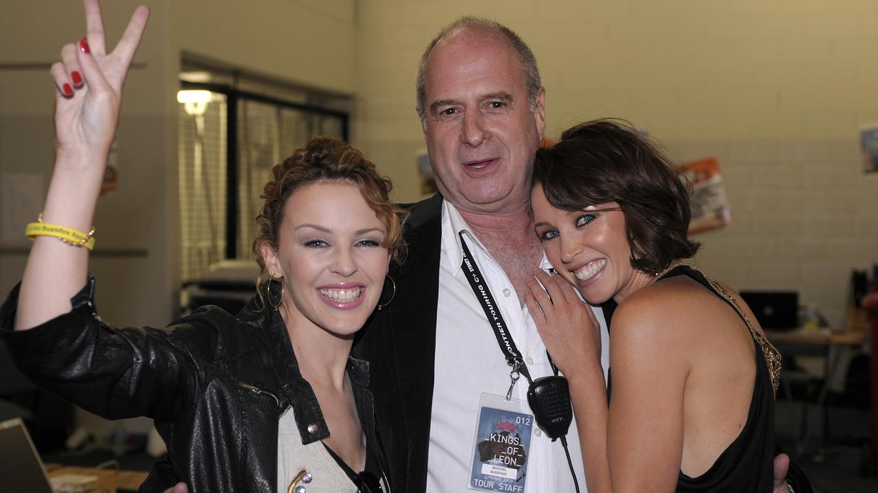 Kylie Minogue (L) backstage with her sister Dannii Minogue (R) and record executive Michael Gudinski (C) in 2009.