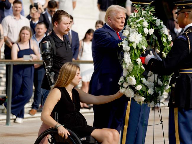 ARLINGTON, VIRGINIA - AUGUST 26: Republican presidential nominee, former U.S. President Donald Trump lays a wreath alongside Marine Cpl. Kelsee Lainhart (Ret.) and and U.S. Marine Corps. Sergeant Tyler Vargas-Andrews (Ret.) who were injured at the Abbey Gate Bombing, during a wreath-laying ceremony at the Tomb of the Unknown Soldier at Arlington National Cemetery on August 26, 2024 in Arlington, Virginia. Monday marks three years since the August 26, 2021, suicide bombing at Hamid Karzai International Airport, which killed 13 American service members.   Anna Moneymaker/Getty Images/AFP (Photo by Anna Moneymaker / GETTY IMAGES NORTH AMERICA / Getty Images via AFP)