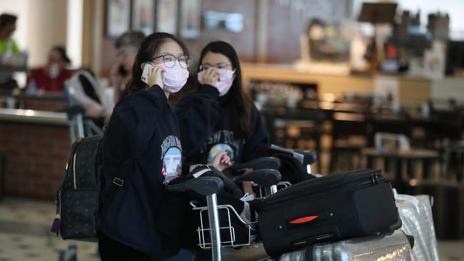 People arrive from Shanghai into Brisbane International Airport. Pic Peter Wallis