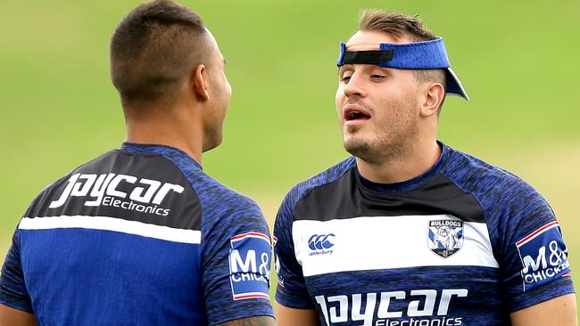 Michael Lichaa and Josh Reynolds sort it all out during training.