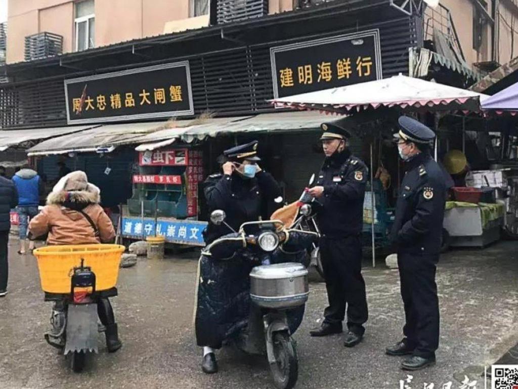 Police guard the Huanan Seafood Wholesale Market, which has been linked to a mysterious flu-like virus. Picture: Yangtze Daily