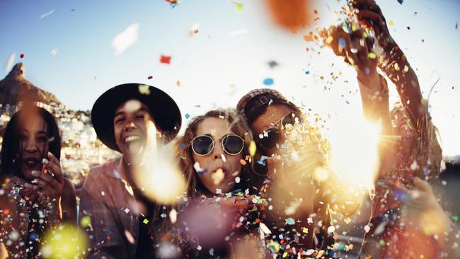 Commercial. Group of teenager friends partying and throwing colorful confetti from hands with sunset. Reef Hotel Casino. Cairns Eye Australia Day feature 21/01/17