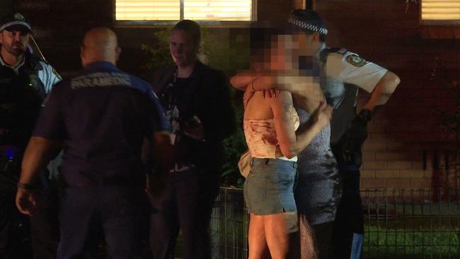 A woman is comforted by another as police investigate the scene at Riverstone. Picture: TNV