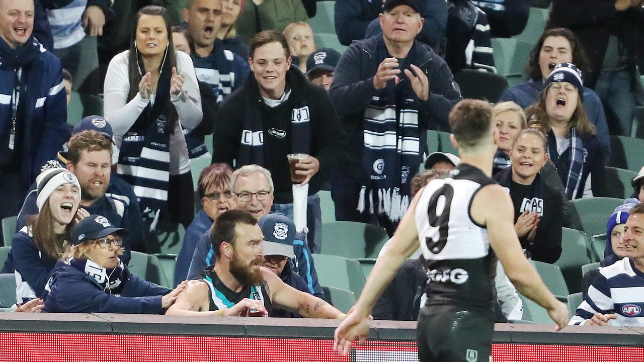 Port Adelaide's Charlie Dixon ends up sitting in the stands with Geelong fans during the 2020 Qualifying Final at Adelaide Oval. Picture: Sarah Reed