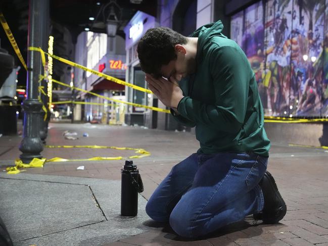 Matthias Hauswirth of New Orleans prays on the street near the scene where a vehicle drove into a crowd. Picture: AP /George Walker IV