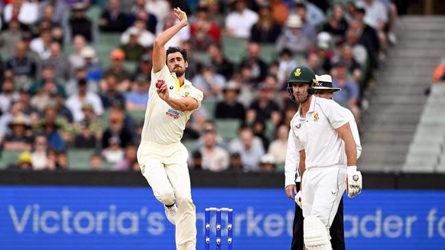 Mitch Starc was not impressed by Theunis de Bruyn (right) wandering out of his crease.