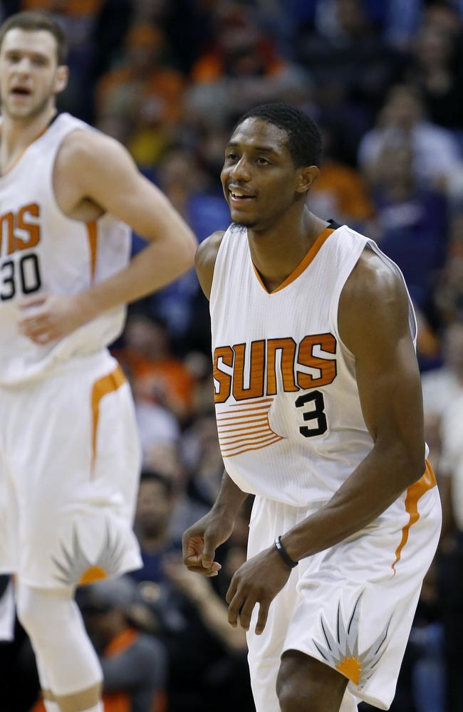 Phoenix Suns' Brandon Knight smiles after making a 3-point shot against the Minnesota Timberwolves as teammate Jon Leuer shouts in celebration during the second half.