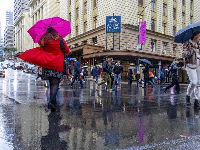 BRISBANE AUSTRALIA - NewsWire NCA Photos JULY 5, 2022: Queenslanders rug up as heavy rain and colder than average temperatures hit Brisbane today. NewsWire / Sarah Marshall