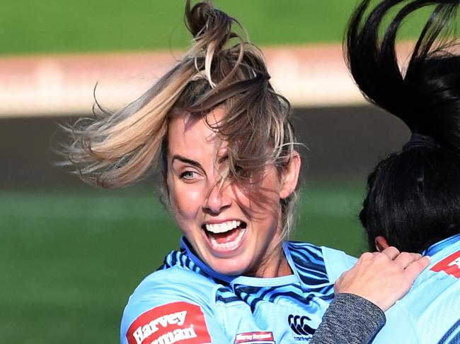 Sam Bremner of the NSW Blues Women's State of Origin team reacts as she is tackled to the ground by teammate Lavina O'Mealey during their captains run at the North Sydney Oval in Sydney, Thursday, June 21, 2018. (AAP Image/David Moir) NO ARCHIVING