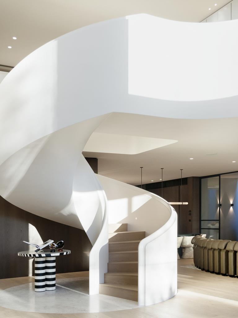 A sculptural spiral staircase is the centrepiece of the home’s bold architectural design.