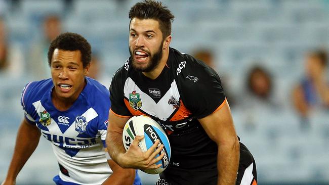 SYDNEY, AUSTRALIA - MARCH 27: James Tedesco of the Tigers makes a break during the round four NRL match between the Wests Tigers and the Canterbury Bulldogs at ANZ Stadium on March 27, 2015 in Sydney, Australia. (Photo by Renee McKay/Getty Images)