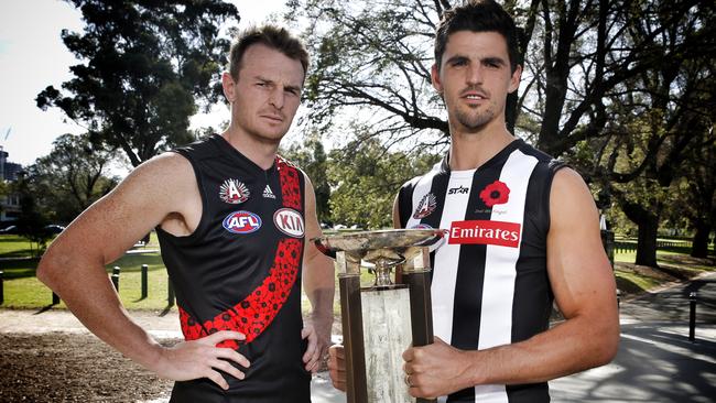 Brendon Goddard and Scott Pendlebury with the Anzac trophy ahead of last year’s clash. Picture: Michael Klein.