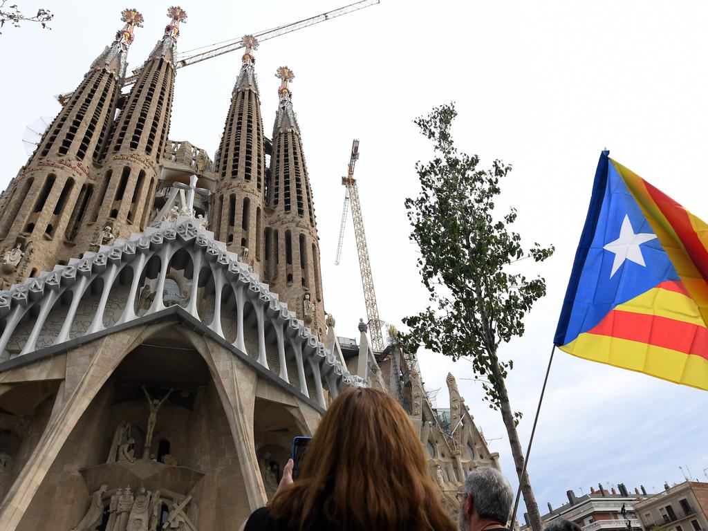 Pro-independence protesters gather in front of the Sagrada Familia basilica in Barcelona on the day that separatists have called a general strike and a mass rally. Picture: AFP