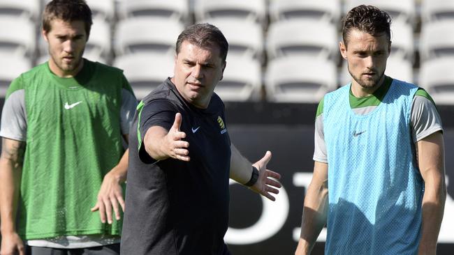 Socceroos' coach Ange Postecoglou, centre, speaks to players during a training session in Sydney.