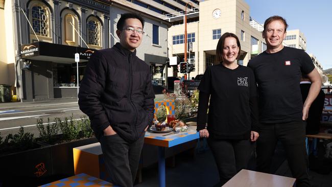 Ho Nguyen of UnPhogettable, Lisa Monro (Monro) of Next Door Coffee, David Painter of Sush with one of the new outdoor dining areas installed in Collins Street. Launch of Transforming Collins Street by City of Hobart. Picture: Nikki Davis-Jones