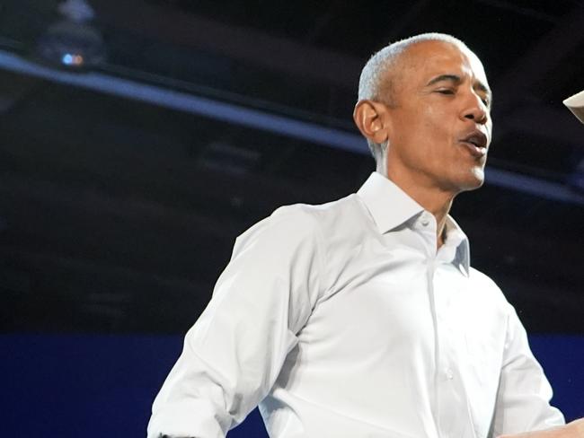 Rapper Eminem, right, greets former President Barack Obama, left, on stage at a campaign rally supporting Democratic presidential nominee Vice President Kamala Harris, Tuesday, Oct. 22, 2024, in Detroit. (AP Photo/Paul Sancya)