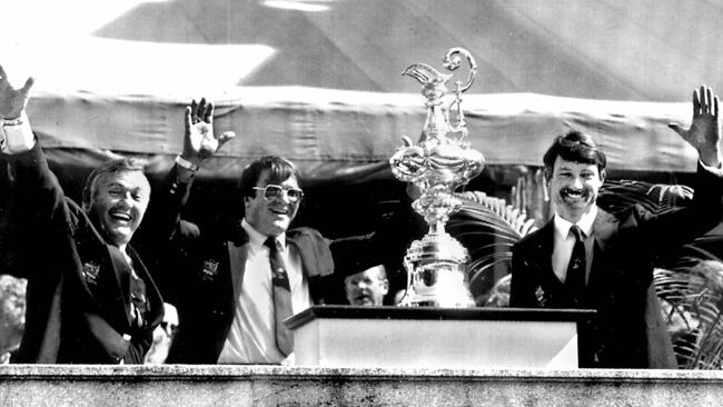 Australia II owner Alan Bond, left, designer Ben Lexcen and skipper John Bertrand with the America's Cup trophy during presentation ceremony after deafeating USA yacht in winning the series at Newport, Rhode Island, in 1983.