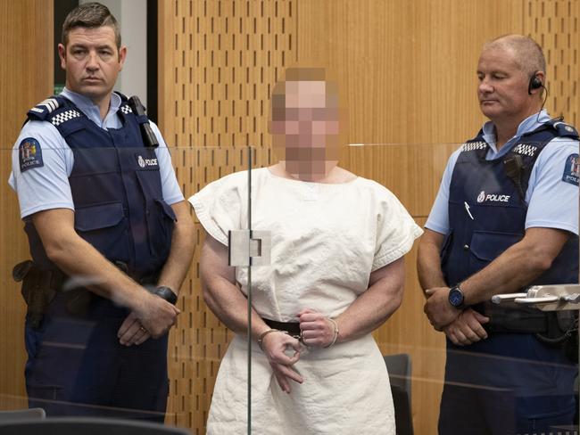 Brenton Tarrant making a sign to the camera during his appearance, for murder, in the Christchurch District Court. Picture: New Zealand Herald photograph by Mark Mitchell