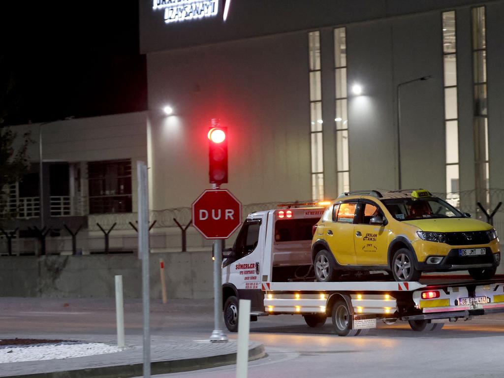 A taxi car which was allegedly used by attackers is evacuated from the site near the Turkish Aerospace Industries (TAI) building. Picture: Adem ALTAN / AFP