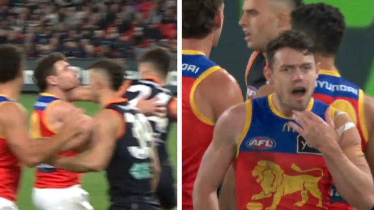 Lachie Neale reacts to being struck by Carlton's Nic Newman.