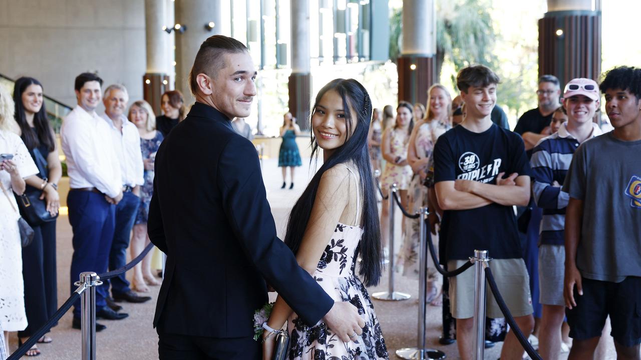 Melody Neal arrives at the Peace Lutheran College formal evening at the Cairns Convention Centre with her date Hunter Smith. Ms Neal was the victim of a stabbing at the school on May 16, which damaged her liver and severed nerves in her spine. Picture: Brendan Radke