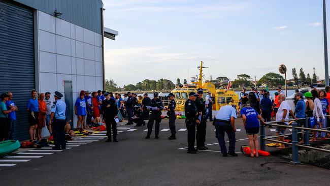 Police question protesters at the Port of Newcastle. Picture: Roni Bintang/Getty Images