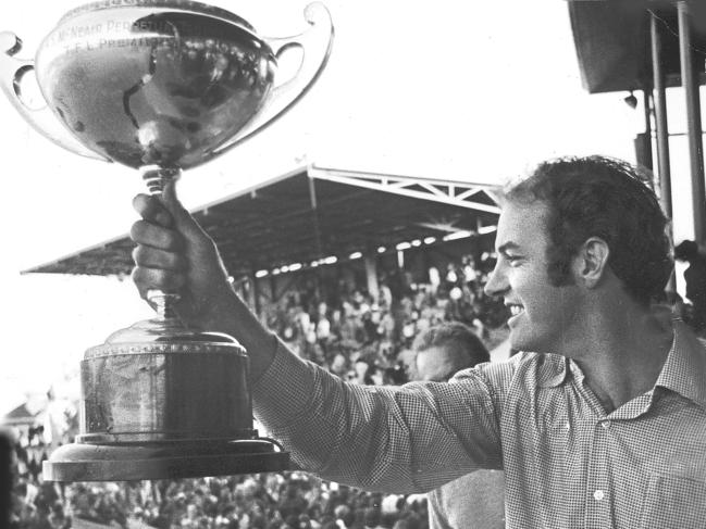 John Devine shows the North Hobart crowd the 1974 premiership. Picture Barry Winburn