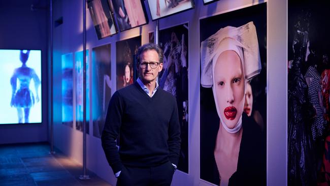 Robert Fairer with his photographs of McQueen shows exhibited within NGV International’s Alexander McQueen: Mind Mythos Muse. Picture: Eugene Hyland