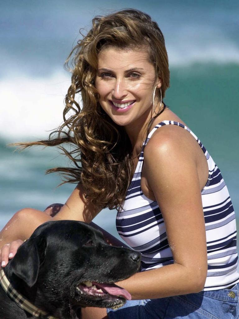 Mannequin and fashion designer Jodhi Packer and dog Tenzin on Bondi Beach 10 Aug 2001.