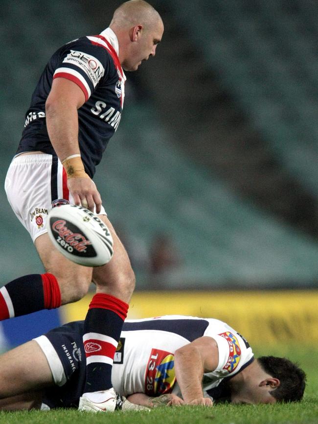 Mark O'Meley stands over the Broncos’ Joel Clinton.