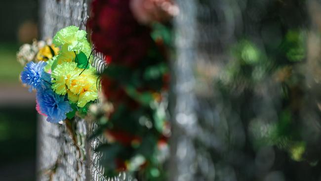 Floral tributes at the scene of an alleged murder in Driver. Picture: Glenn Campbell