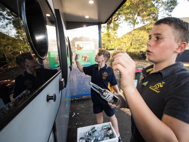 Pullin brothers Fergus, 13 and Hamish, 11, earning some pocket money from depositing bottles at Addison Rd.