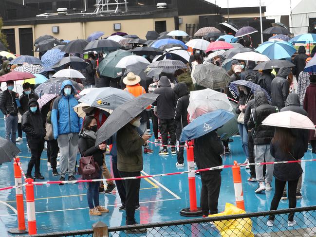 People line up at a vaccination hub in St Kilda. Picture: David Crosling