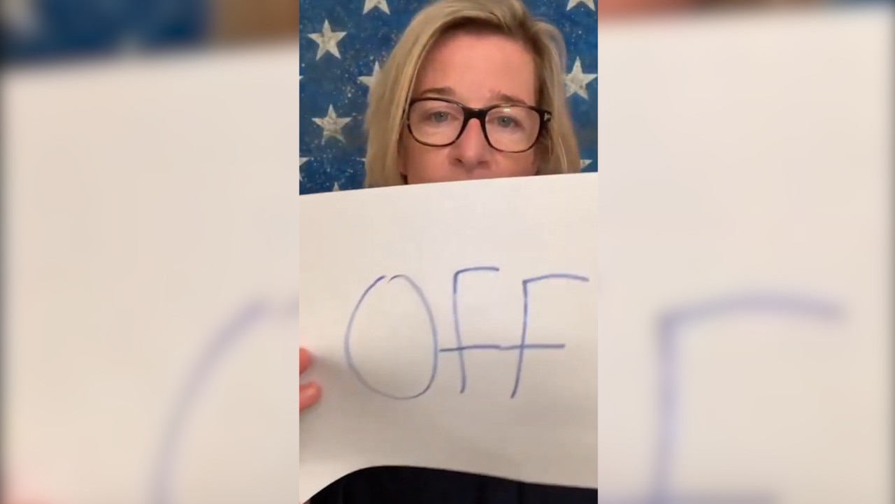 Still from Katie Hopkins video of her holding a sign saying 'SOD OFF'