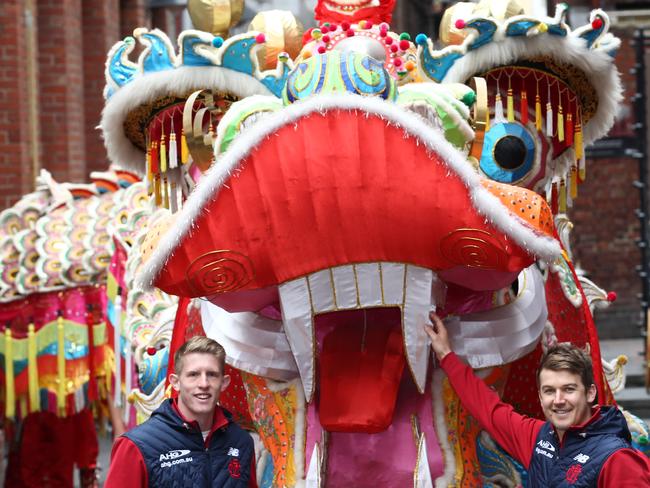 Jack Trengove and Sam Frost from Melbourne with a dragon in Melbourne's China town. Picture: David Crosling