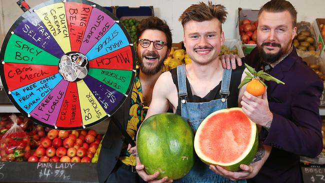 BJ, Harry and Josh with their prize wheel, which a customer can spin when they spend $50. Picture: Ian Currie