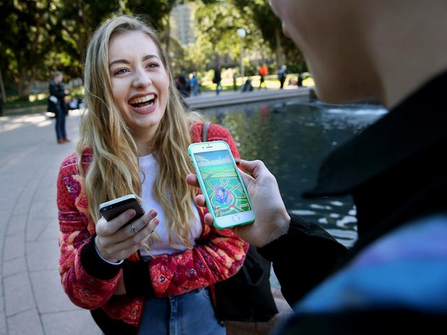 Tamra Foy and Finn Melville playing Pokemon Go at Hyde Park. Picture: Richard Dobson