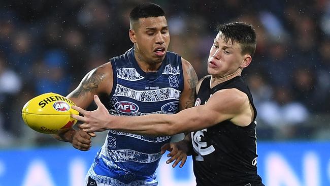 Sam Walsh nudges the ball away from Tim Kelly. Picture: AAP Image/Julian Smith.