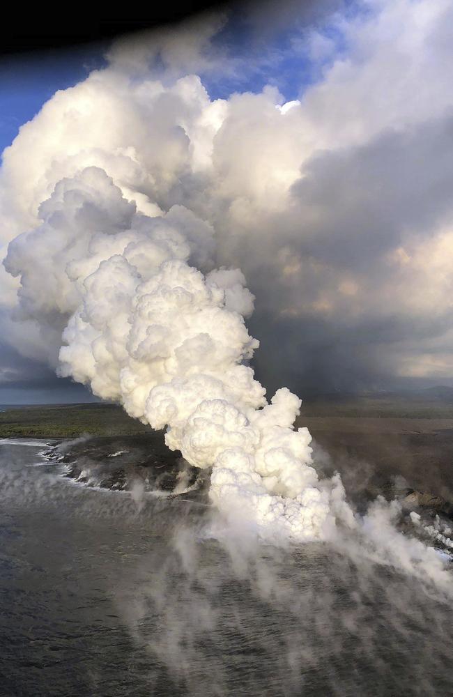 Steam and ash rise from new land formed by lava from Kilauea Volcano where the bay and village of Kapoho once stood on the island of Hawaii. Picture: US Geological Survey via AP