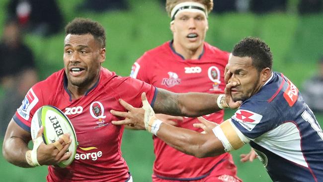 MSamu Kerevi of the Reds tries to fend off Sefanaia Naivalu.