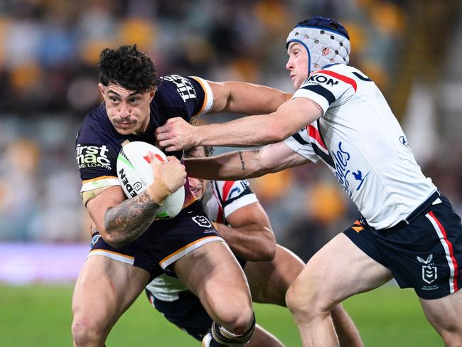 Broncos star Kotoni Staggs is tackled by Roosters' Luke Keary. Picture: NRL Photos