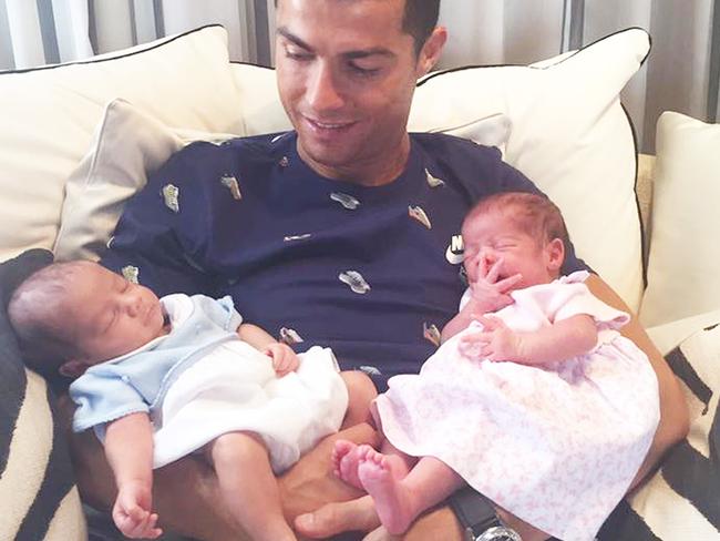 Cristiano Ronaldo with his twin children, who were born via a surrogate.