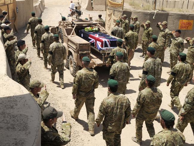 Special Operations Task Group, Coalition and Afghan soldiers form a guard of honour along the route to the Tarin Kowt airfield during the ramp ceremony for Sergeant Brett Wood, who was killed in action.